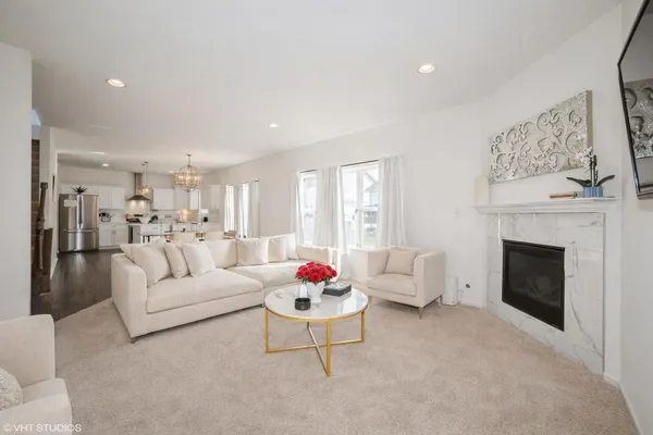 a living room with furniture white walls and a fireplace