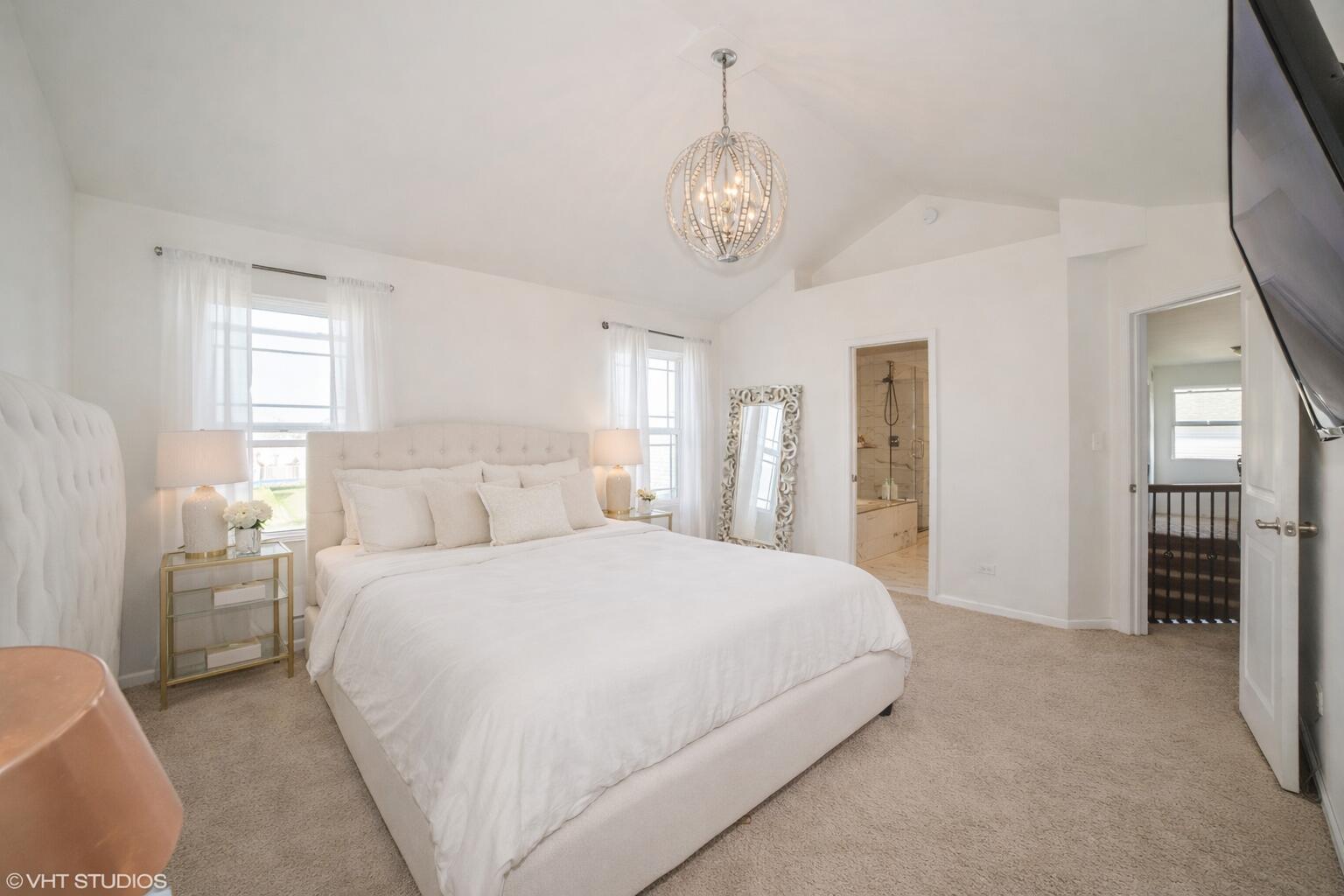 8569 Marshall Street Merrillville, IN 46410 - Photo 6 of 10 a bedroom with a large bed and a chandelier