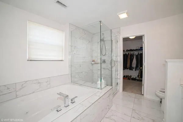 a bathroom with a bathtub and a shower