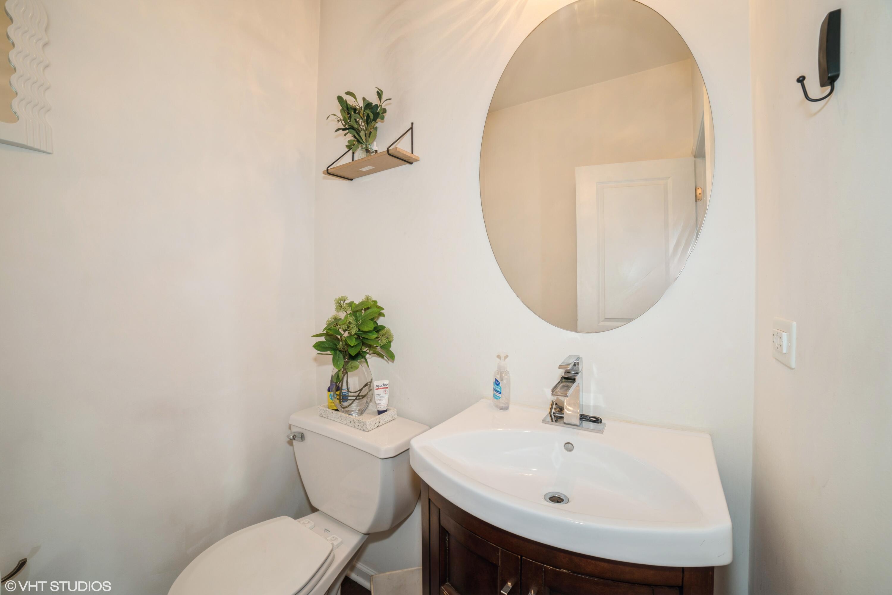 8569 Marshall Street Merrillville, IN 46410 - Photo 10 of 13 a bathroom with a sink mirror and toilet