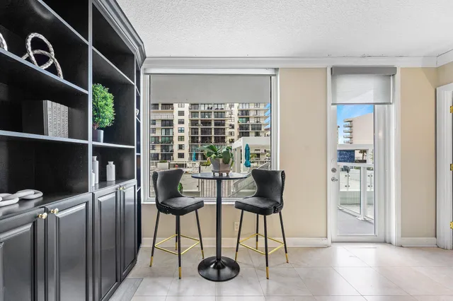 a living room with furniture a flat screen tv and a potted plant