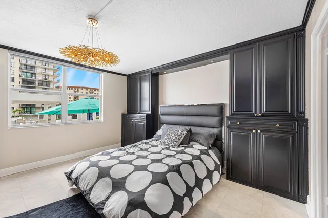 a bedroom with a bed and glass windows