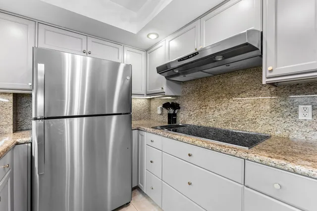 a kitchen with a sink stainless steel appliances and cabinets