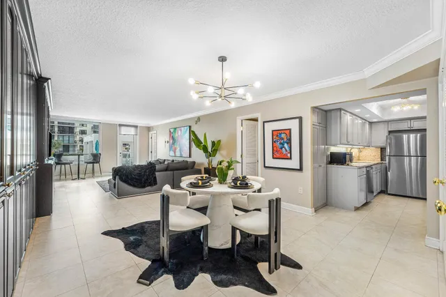 a dining room with furniture a chandelier and wooden floor