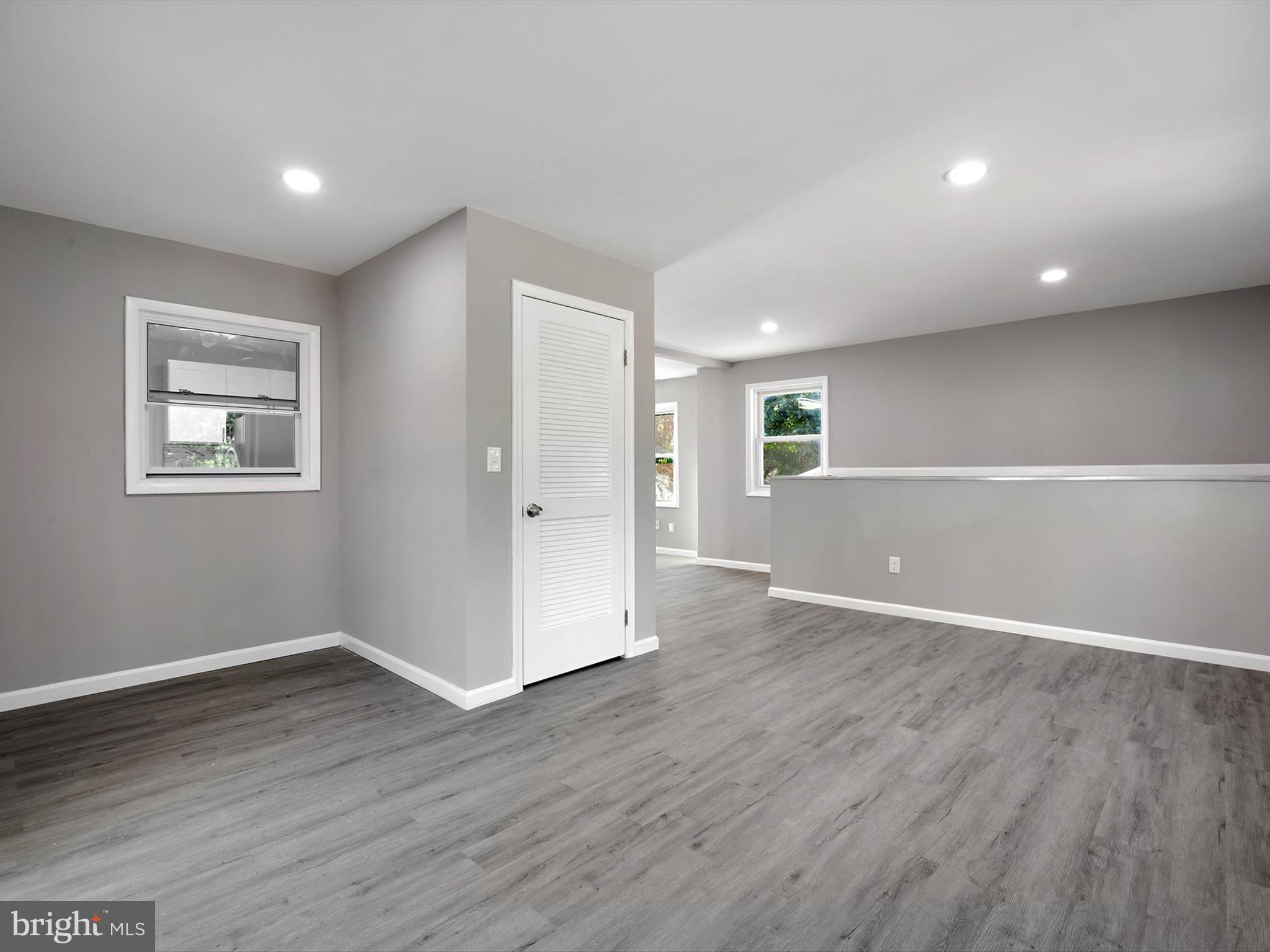 8635 Emory Grove Road Gaithersburg, MD 20877 - Photo 13 of 38 a view of an empty room with wooden floor and a window