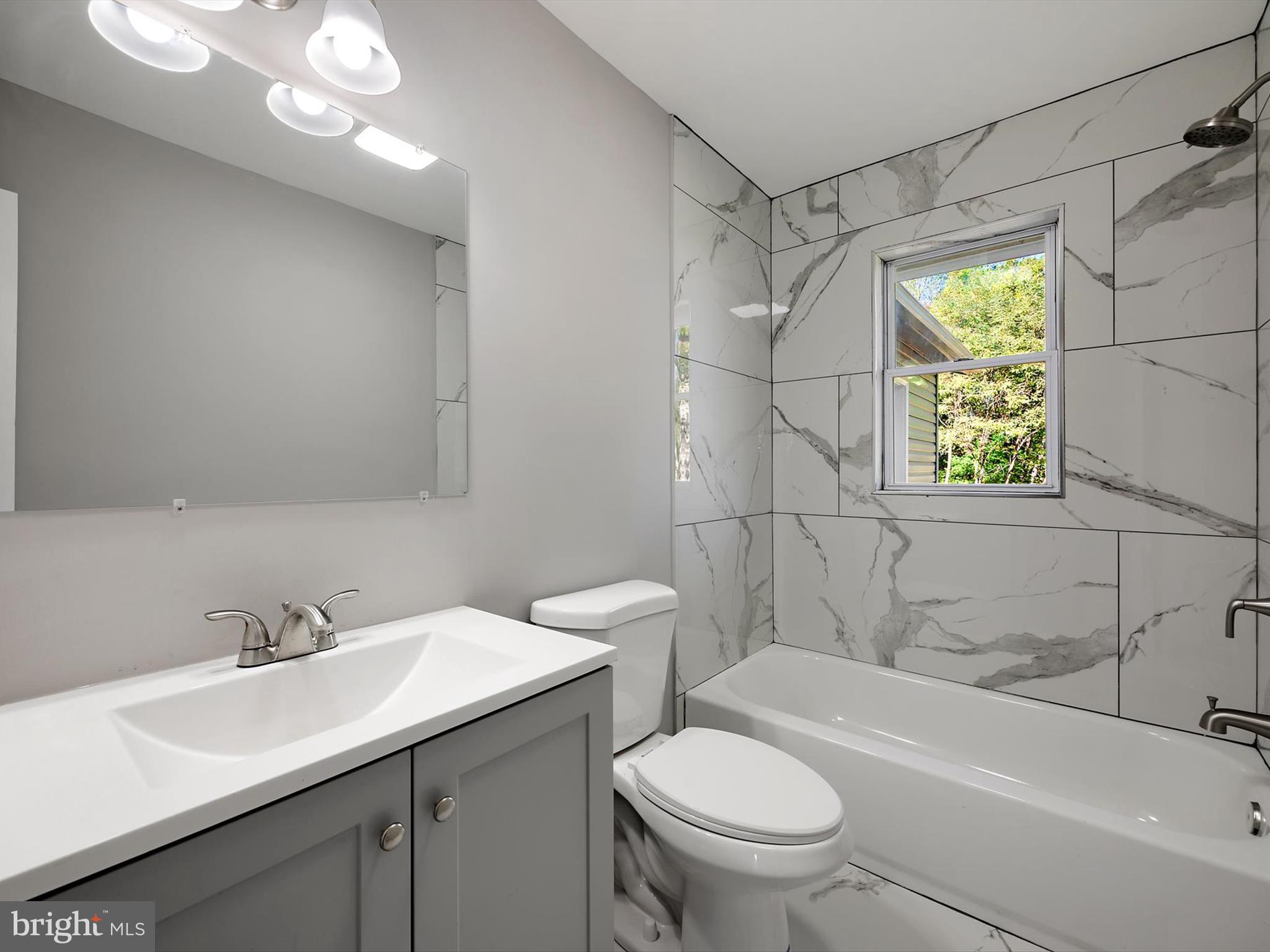 8635 Emory Grove Road Gaithersburg, MD 20877 - Photo 17 of 38 a bathroom with a sink a toilet and shower