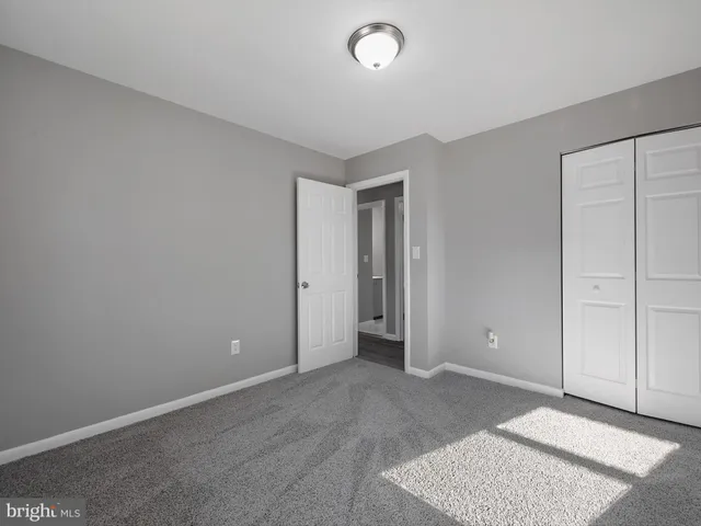 an empty room with closet area
