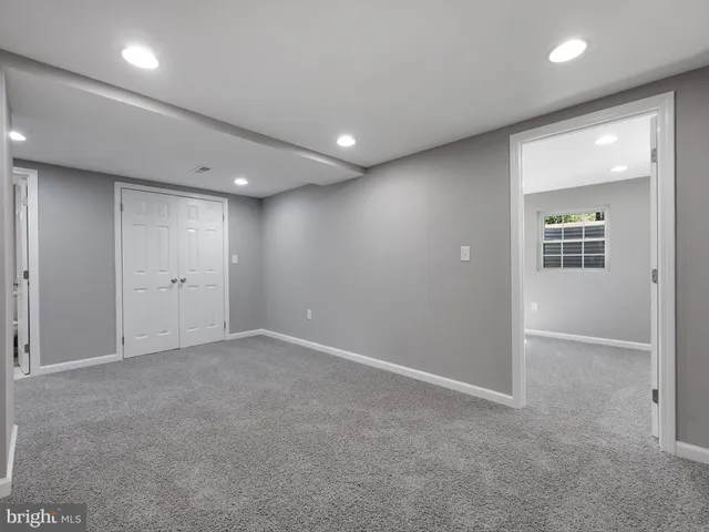 an empty room with windows and closet