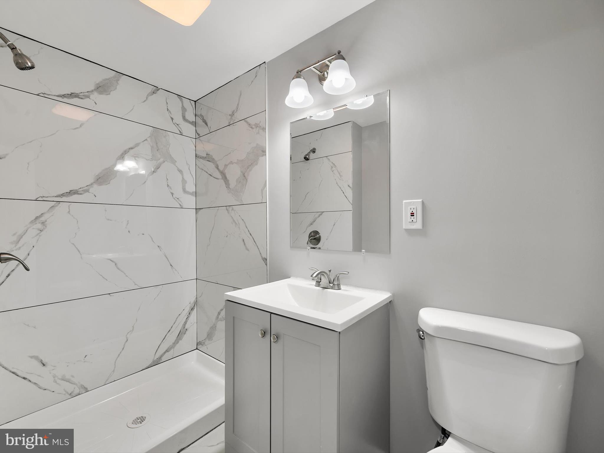 8635 Emory Grove Road Gaithersburg, MD 20877 - Photo 29 of 38 a bathroom with a toilet a sink and mirror