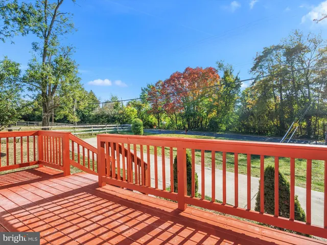 a balcony with wooden floor and fence