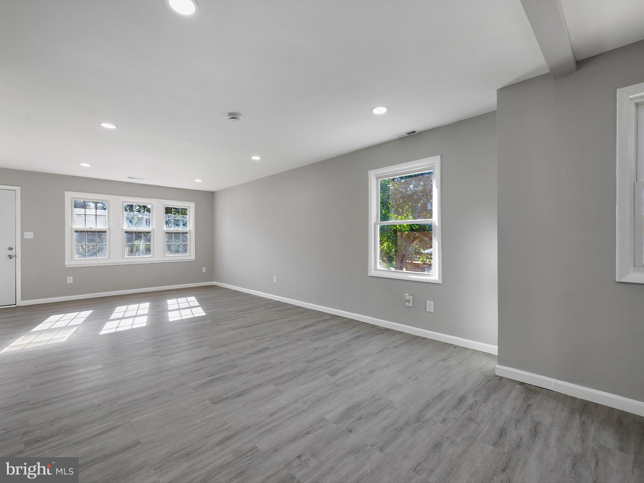 8635 Emory Grove Road Gaithersburg, MD 20877 - Photo 10 of 38 a view of an empty room with a window and wooden floor