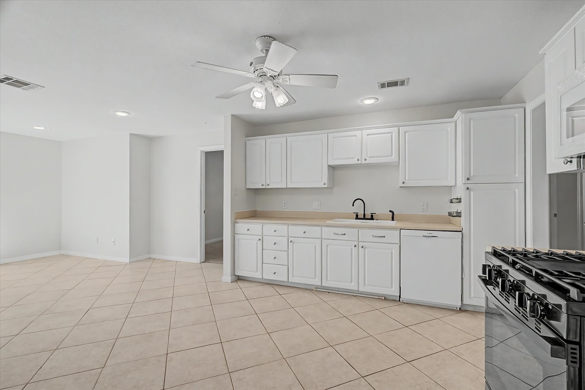 413 Farrer Street Angleton, TX 77515 - Photo 12 of 43 a kitchen with cabinets and window