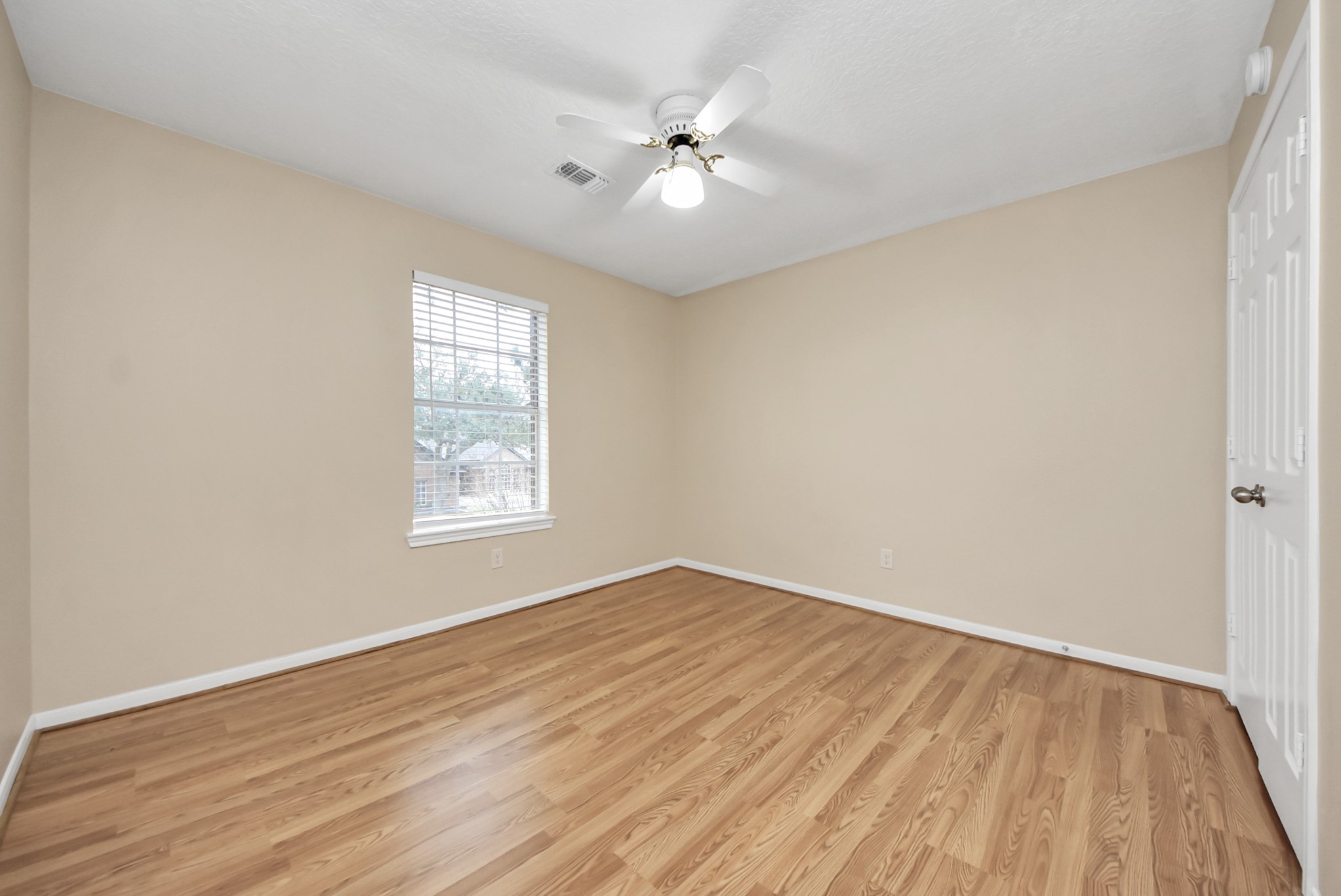 1702 Park Ridge Drive Katy, TX 77450 - Photo 15 of 30 an empty room with wooden floor and windows