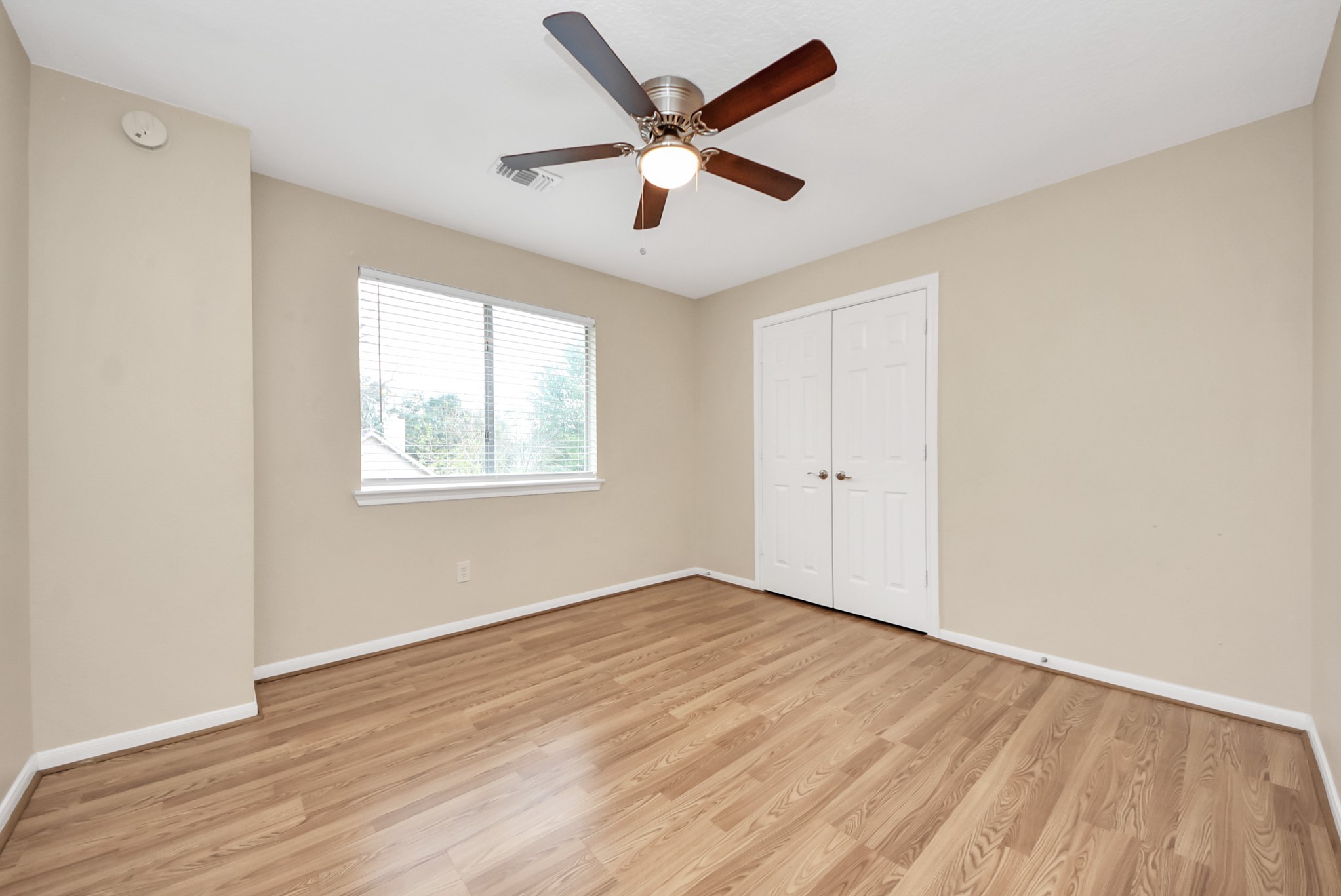 1702 Park Ridge Drive Katy, TX 77450 - Photo 20 of 30 an empty room with wooden floor and windows