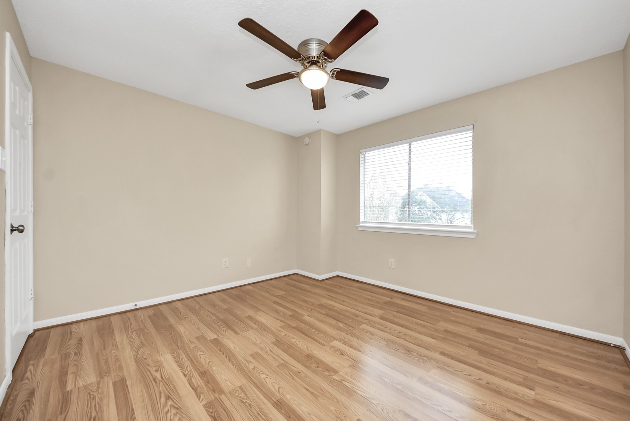1702 Park Ridge Drive Katy, TX 77450 - Photo 21 of 30 an empty room with wooden floor and ceiling fan
