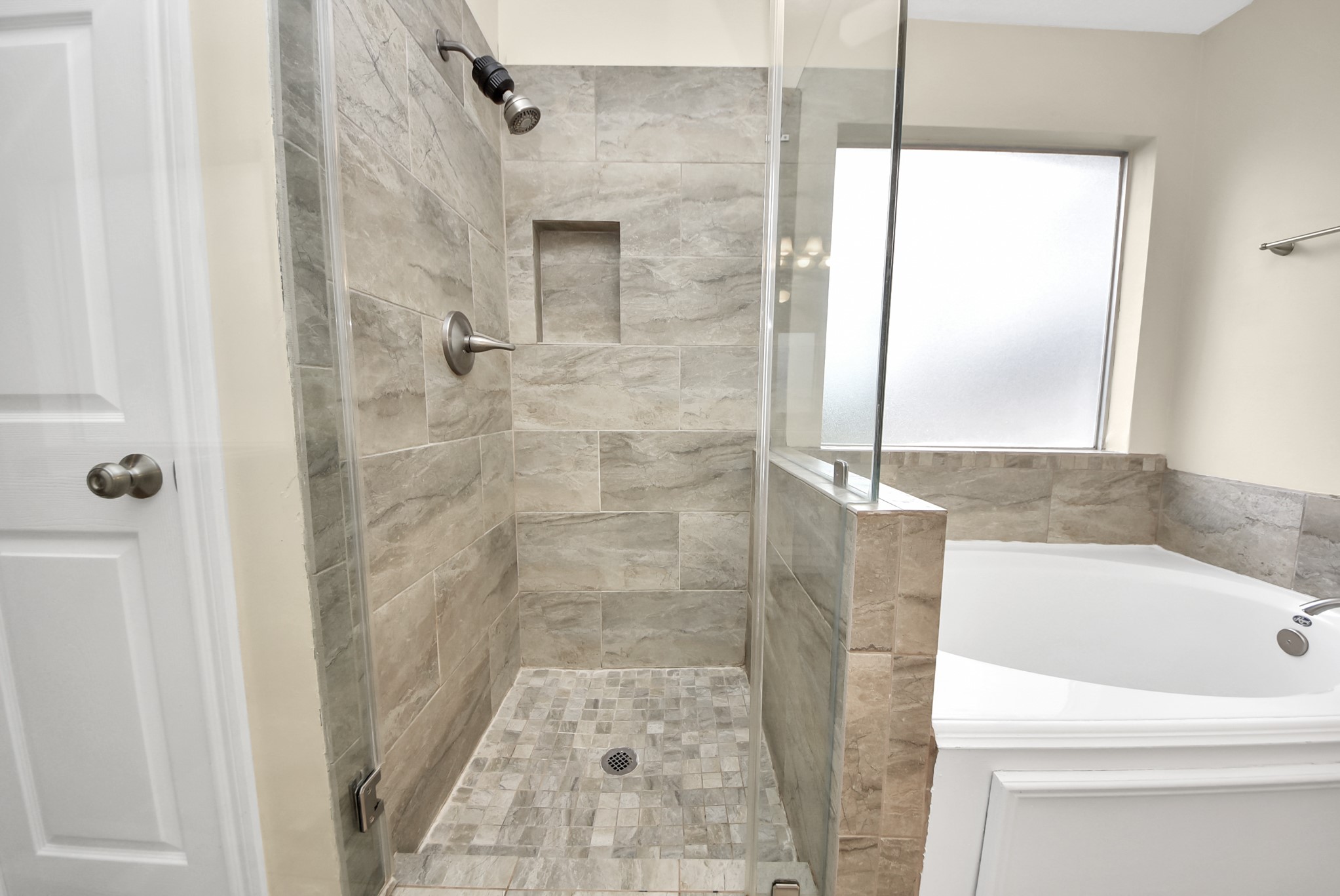 1702 Park Ridge Drive Katy, TX 77450 - Photo 24 of 30 a bathroom with a bathtub and a shower