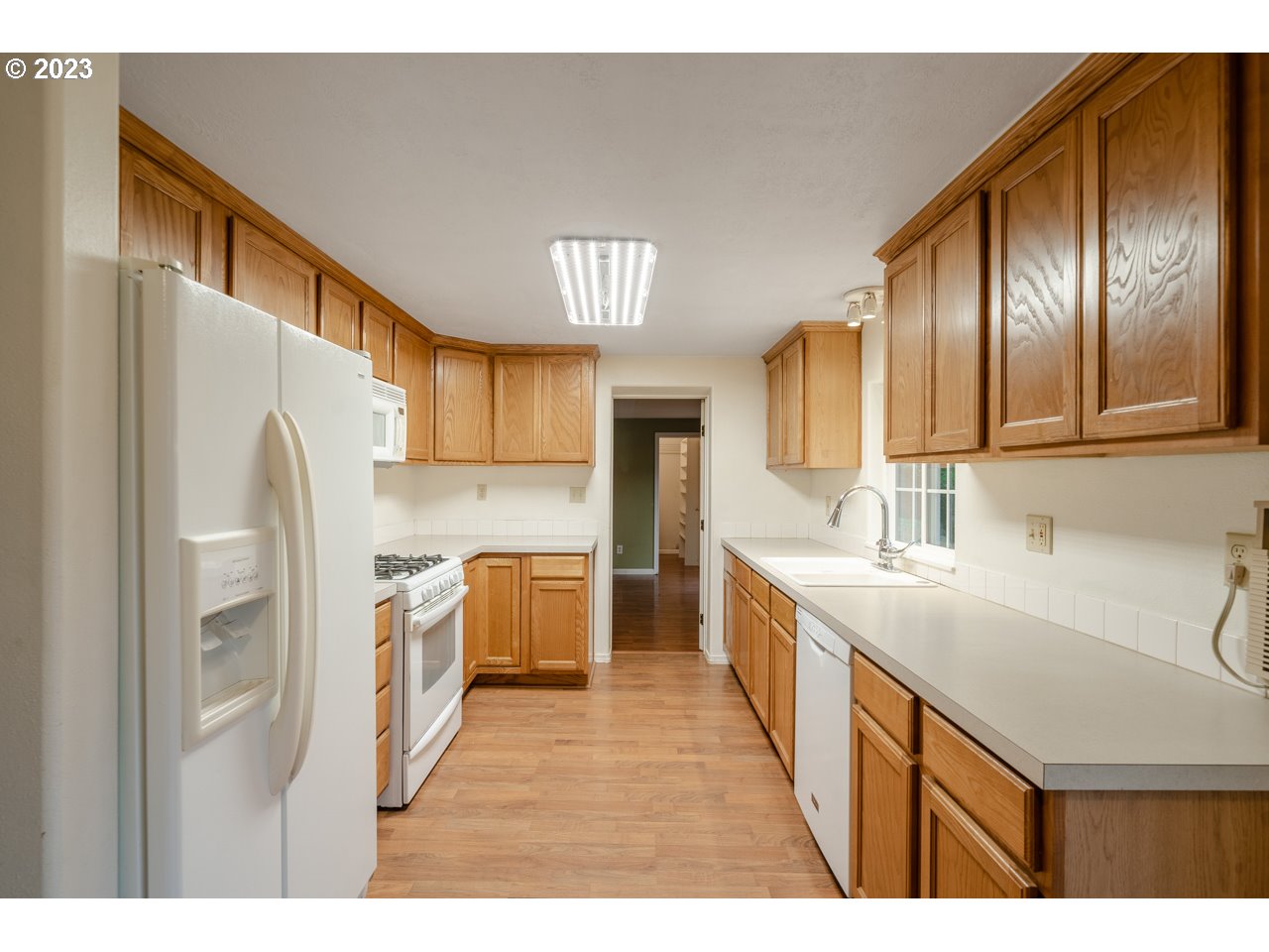 43220 Southeast Pagh Road Sandy, OR 97055 - Photo 8 of 28 a kitchen with stainless steel appliances granite countertop a refrigerator a sink dishwasher a stove with wooden cabinets