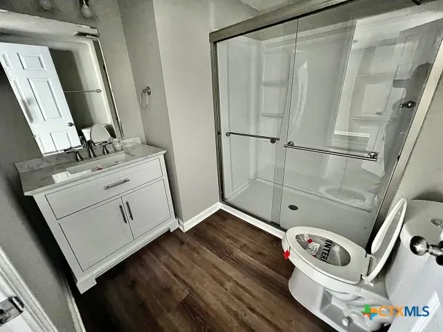 a bathroom with a sink mirror and toilet