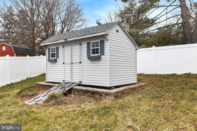 a view of a white house with a yard