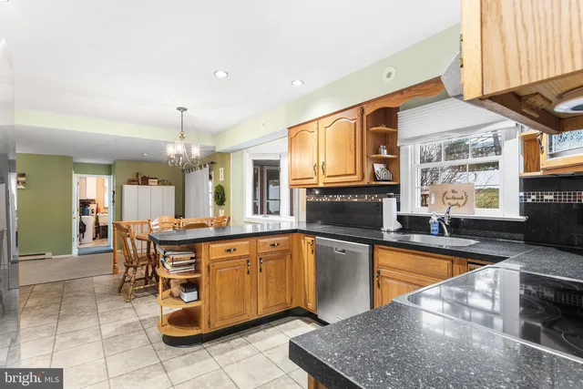 a large kitchen with a table and chairs in it