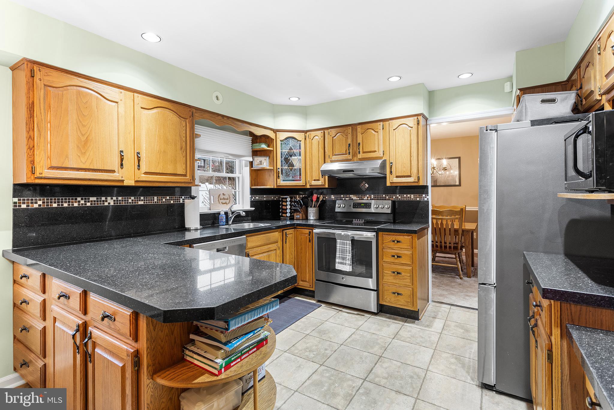 241 Diamond Street Souderton, PA 18964 - Photo 17 of 35 a kitchen with stainless steel appliances granite countertop a stove a sink and a refrigerator