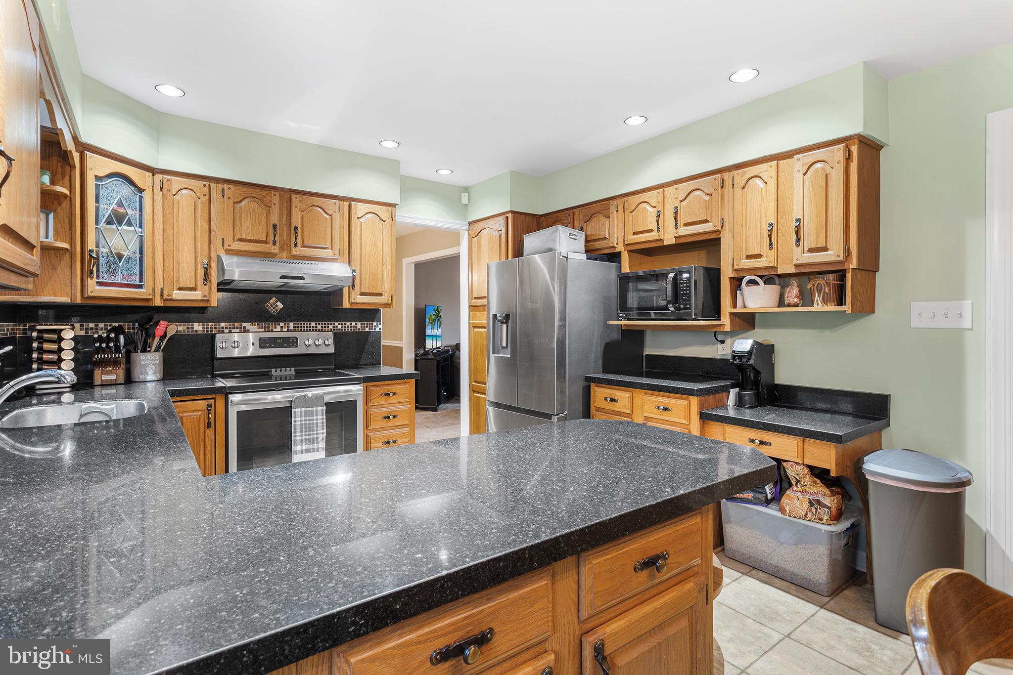 241 Diamond Street Souderton, PA 18964 - Photo 19 of 35 a kitchen with stainless steel appliances granite countertop a sink a stove and a refrigerator