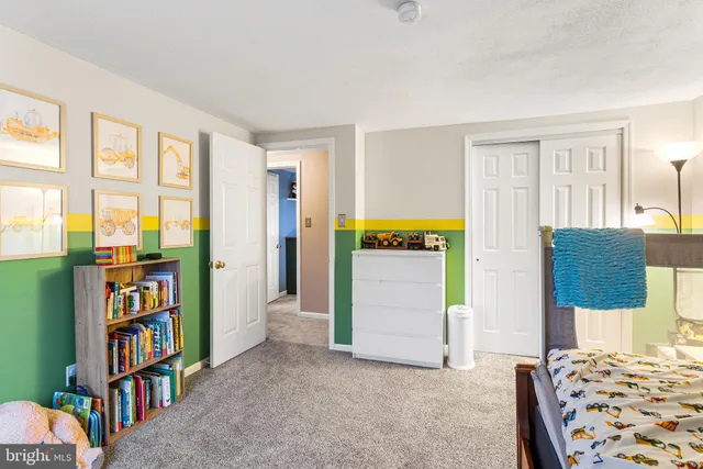 a bedroom with furniture and a book shelf