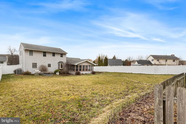 a view of a house with yard and ocean view