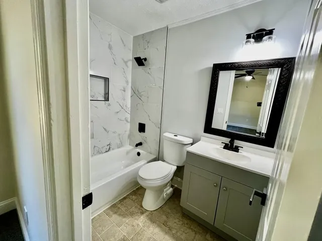 a view of room with a ceiling fan and window