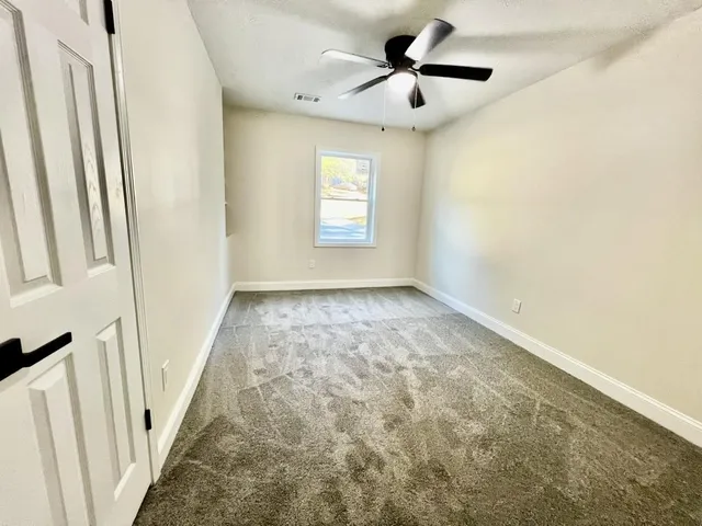 a view of a room with a ceiling fan