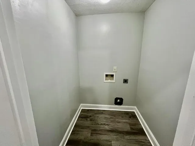 a view of a room with wooden floor and white doors