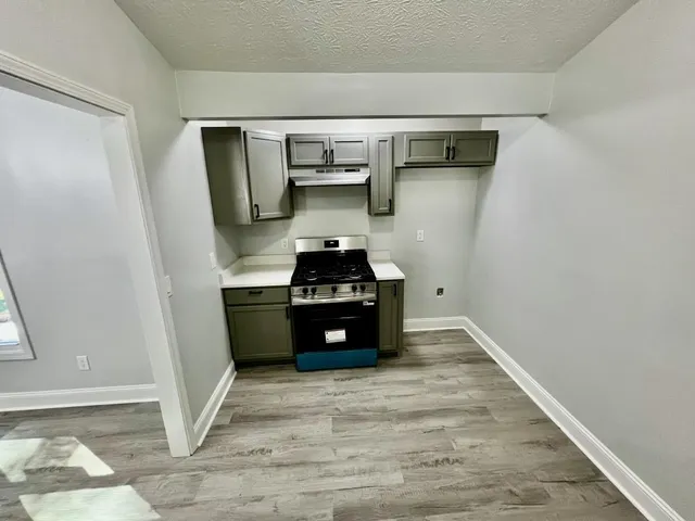 a kitchen with a refrigerator and a stove