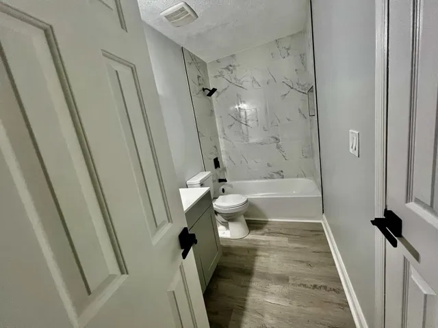 a bathroom with a tub and toilet