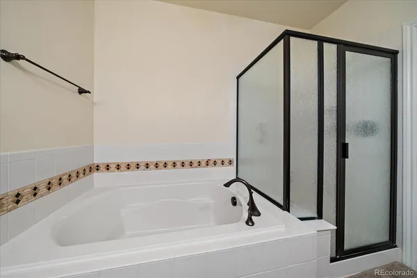 a bathroom with a bathtub and a shower
