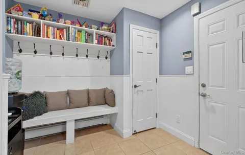 a living room with furniture and a book shelf