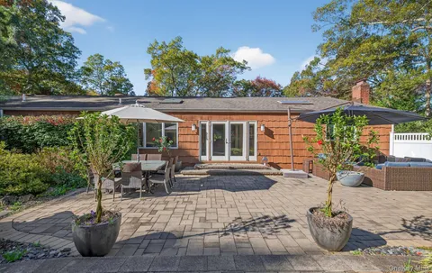 a view of a house with backyard sitting area and tub