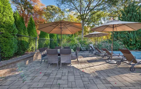 an outdoor space with patio and white umbrellas