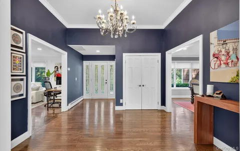 a view of a dining room with furniture wooden floor and chandelier