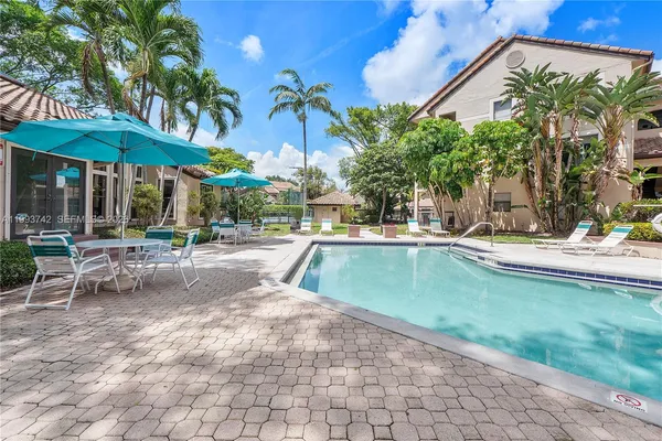 a view of a swimming pool with a patio