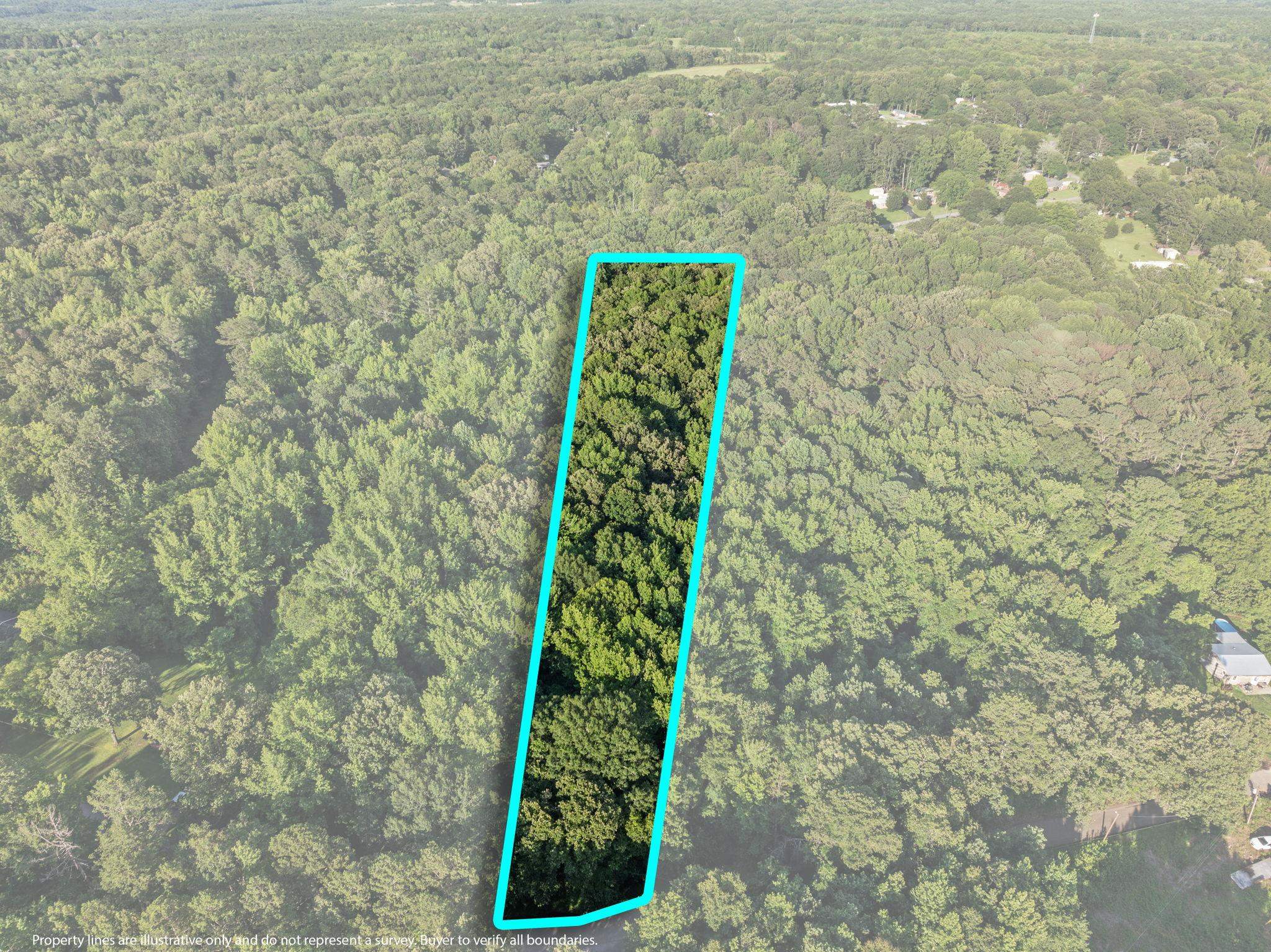 Tbd Spring Street Iuka, MS 38852 - Photo 1 of 12 Aerial view of property and surrounding area featuring a heavily wooded area and property parcel outlined