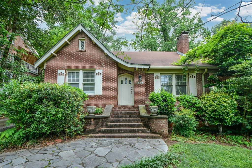 1424 Emory Road Northeast Atlanta, GA 30306 - Photo 2 of 36 a front view of a house with a yard