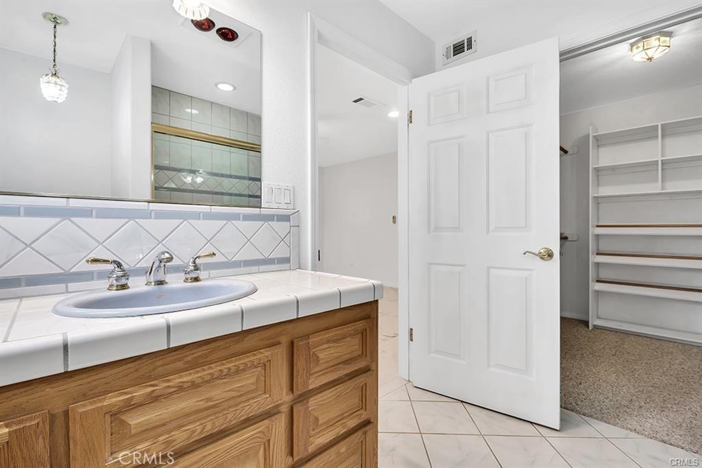 30062 Big Range Road Canyon Lake, CA 92587 - Photo 11 of 20 a bathroom with a sink and a mirror