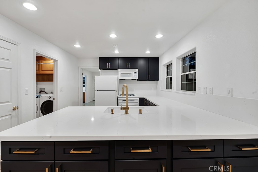 30062 Big Range Road Canyon Lake, CA 92587 - Photo 6 of 20 a living room with stainless steel appliances kitchen island a sink a stove and a refrigerator with wooden floor
