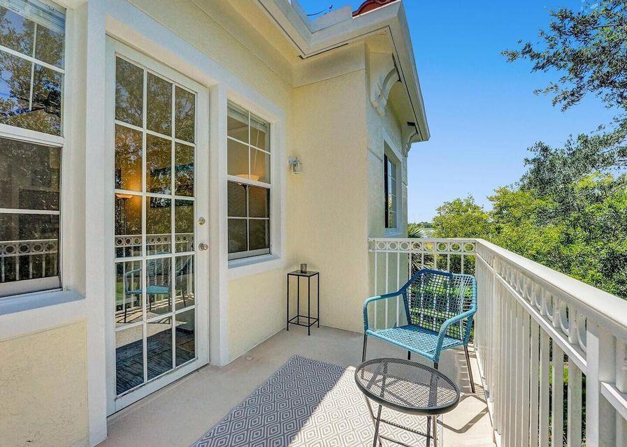 9857 Baywinds Boulevard, Unit 9302 West Palm Beach, FL 33411 - Photo 12 of 45 a balcony with table and chairs