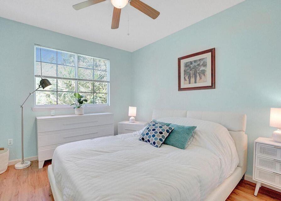 9857 Baywinds Boulevard, Unit 9302 West Palm Beach, FL 33411 - Photo 20 of 45 a bedroom with a large bed and a window