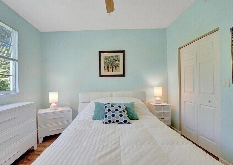 9857 Baywinds Boulevard, Unit 9302 West Palm Beach, FL 33411 - Photo 21 of 45 a bedroom with a large bed and a window