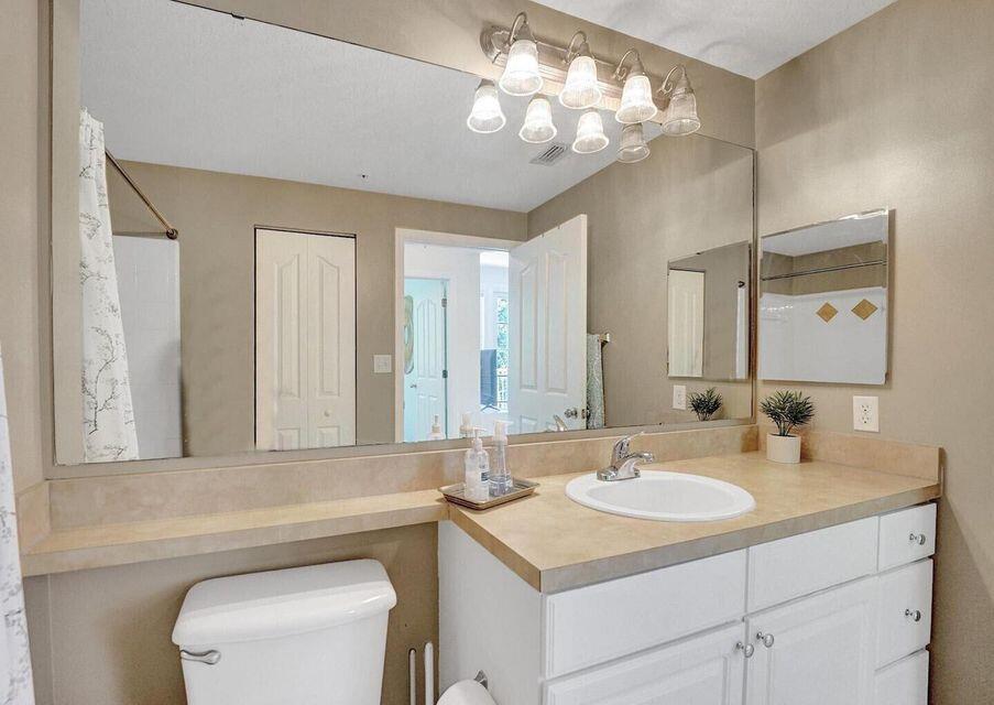 9857 Baywinds Boulevard, Unit 9302 West Palm Beach, FL 33411 - Photo 24 of 45 a bathroom with a sink vanity granite and toilet