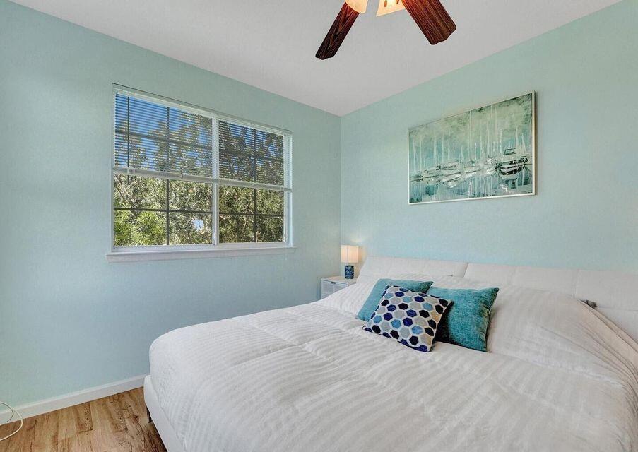 9857 Baywinds Boulevard, Unit 9302 West Palm Beach, FL 33411 - Photo 28 of 45 a bedroom with a bed and a window