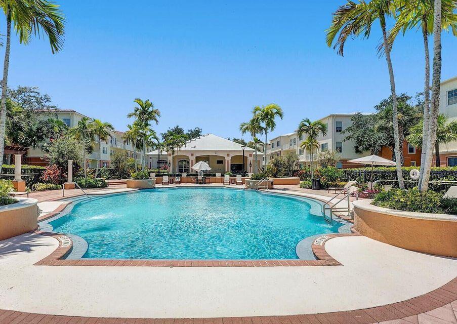 9857 Baywinds Boulevard, Unit 9302 West Palm Beach, FL 33411 - Photo 36 of 45 a view of a swimming pool with a patio