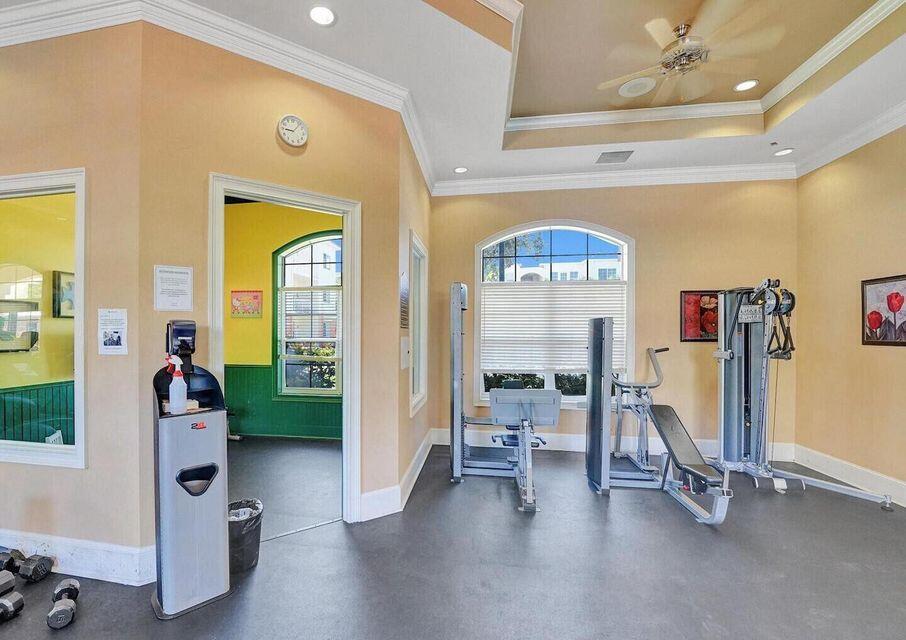9857 Baywinds Boulevard, Unit 9302 West Palm Beach, FL 33411 - Photo 43 of 45 a view of a bedroom with gym equipment